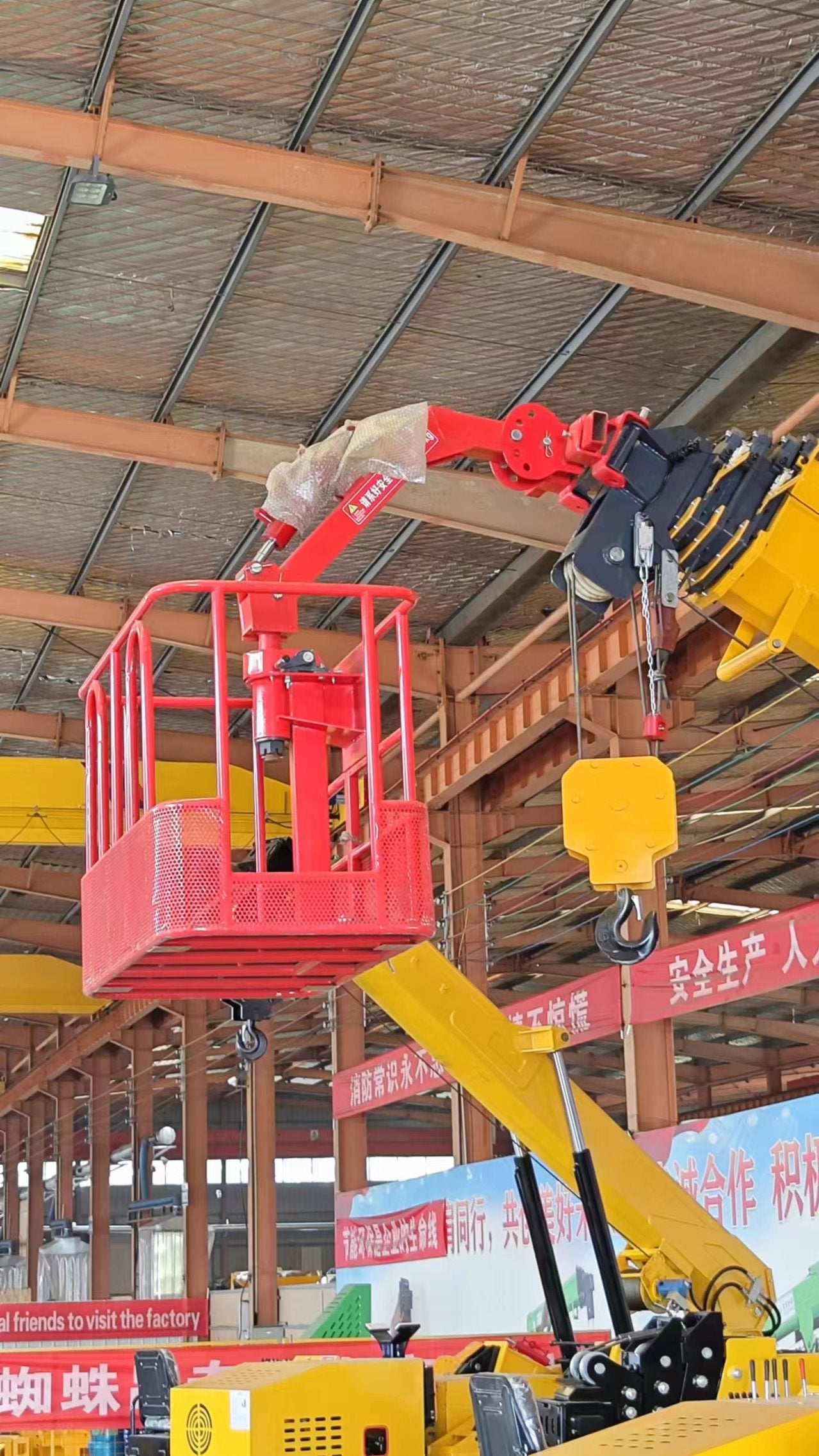 Spider crane fitted with a lifting basket attachment for personnel access work
