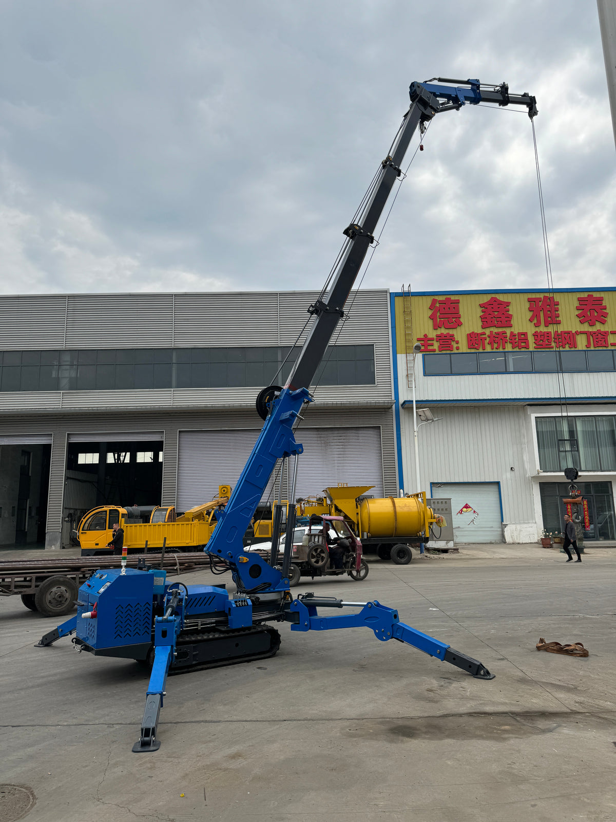 Risenmega spider crane with hydraulic fly arm and searcher hook attachment for extended reach around obstacles