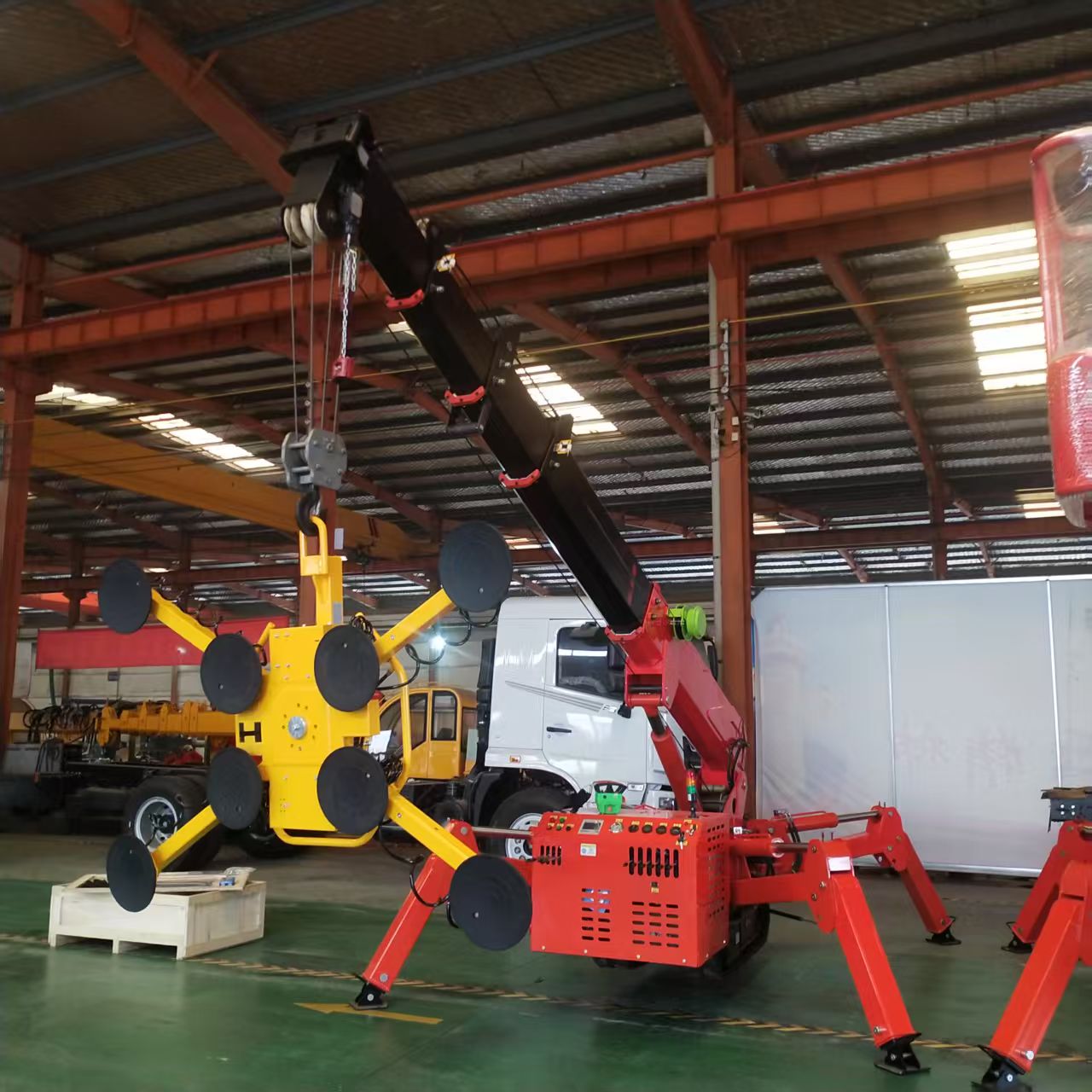 Risenmega spider crane fitted with a vacuum suction cup attachment for glass panel installation